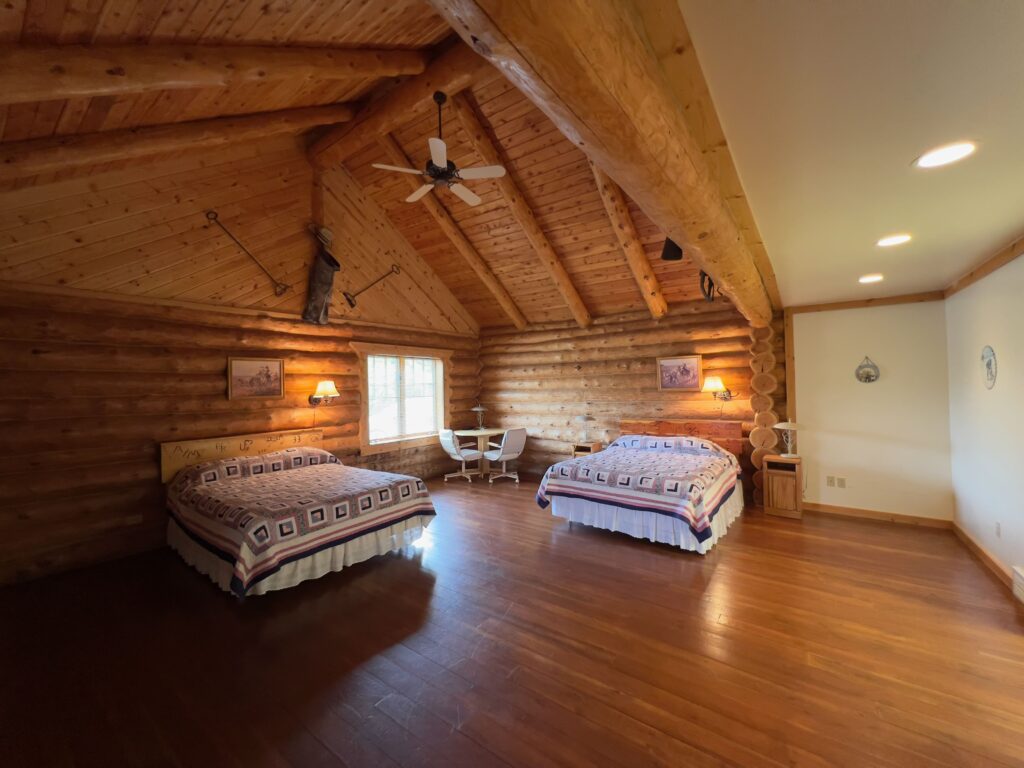 Spacious log cabin bedroom with vaulted ceiling
