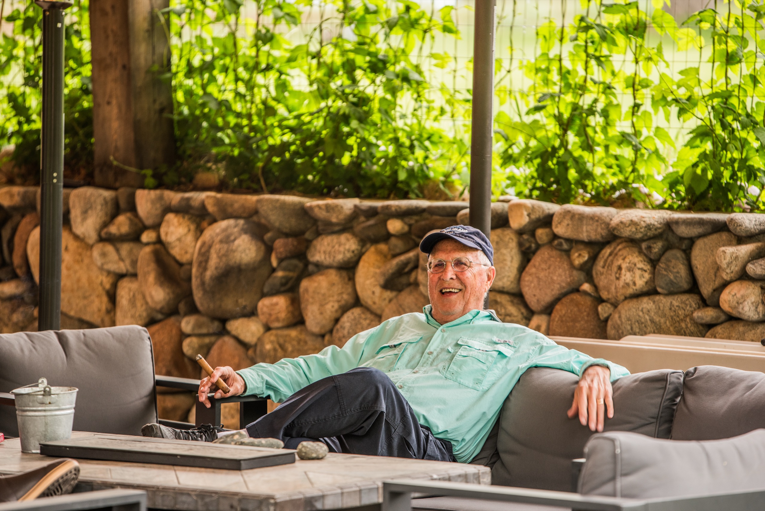 Guest relaxing with a cigar on the stone patio