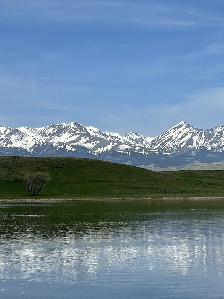 Burns Lake stillwater with snowcapped mountain reflections