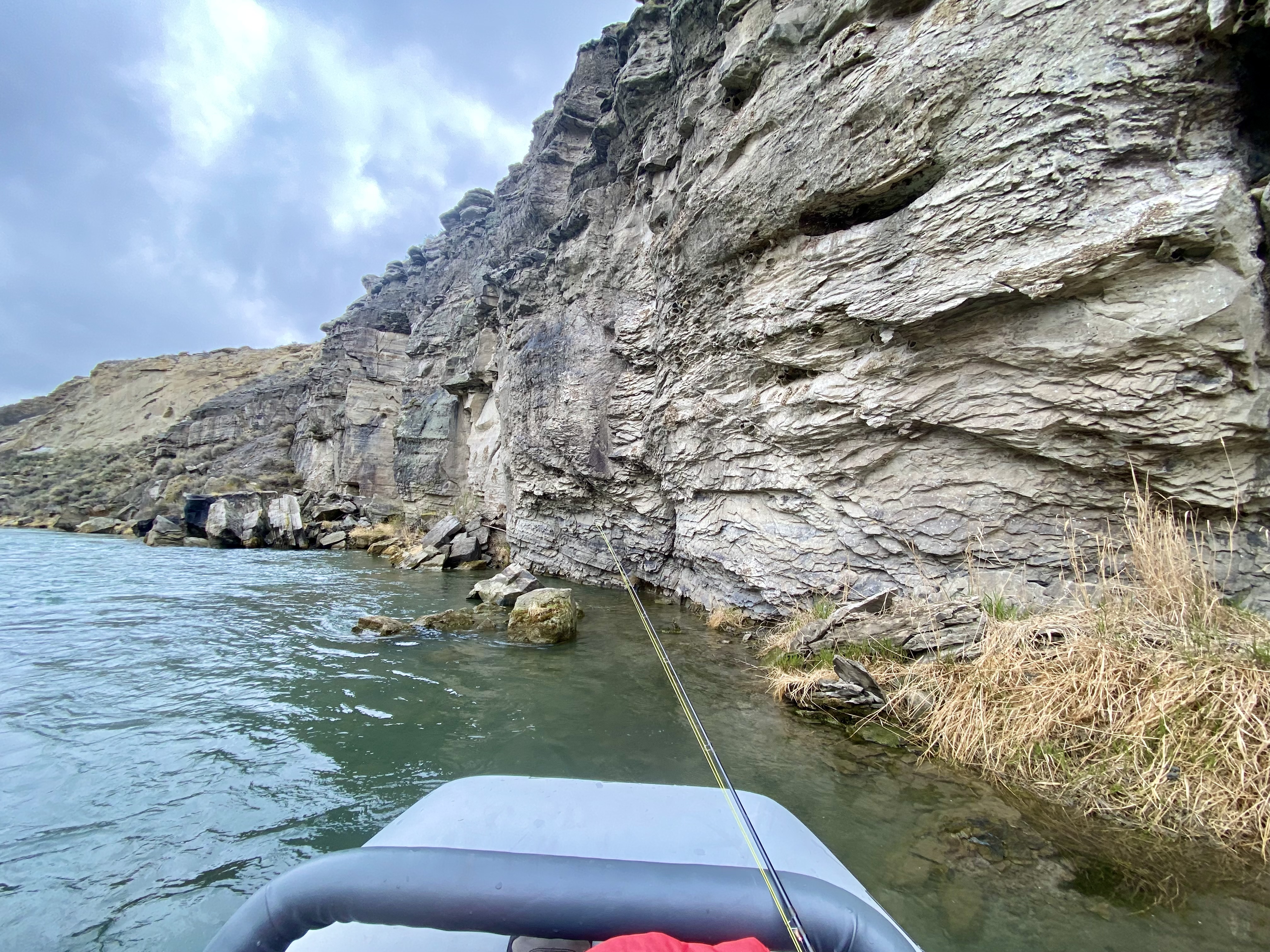 Drift boat navigating dramatic rock walls on the Shoshone