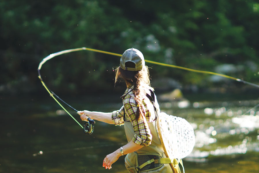 Woman fly casting on a beautiful small river