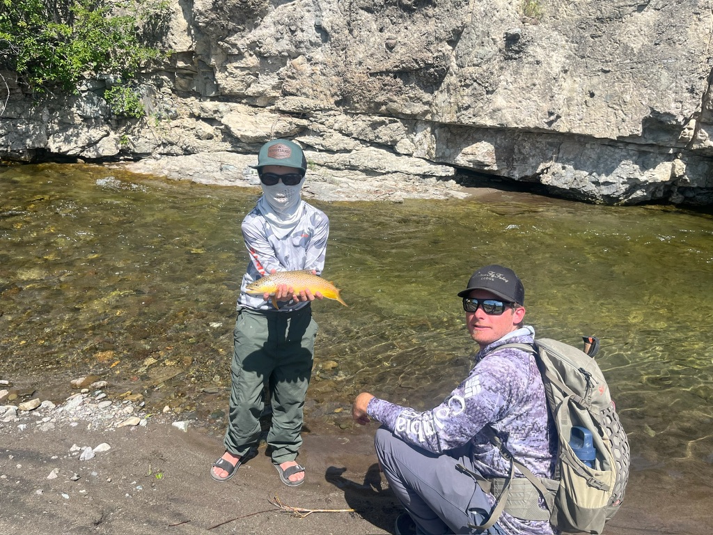 Guide and young angler with a cutthroat on the spring creek